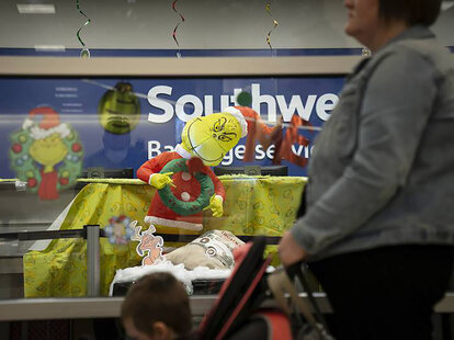 Travelers wait in line for Southwest Airlines luggage services at Midway International Airport in Chicago