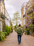 man walking among mews houses in south kensington district, London, UK