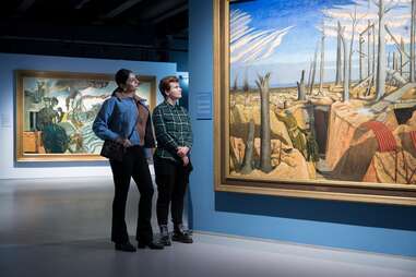 two people admiring painting at imperial war museum london