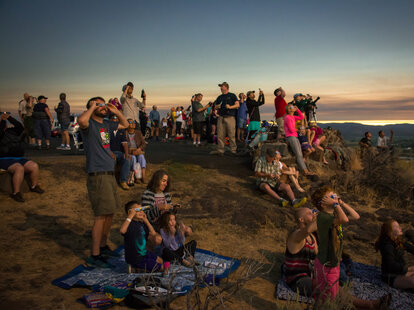 crowd watching eclipse