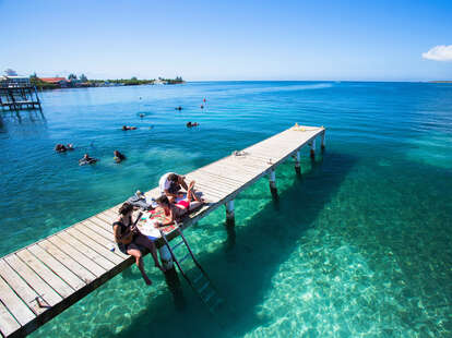 girls hanging out on a dock in Utila 