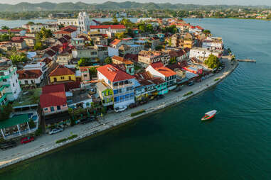 aerial view of boat near the colorful houses of flores island in guatemala