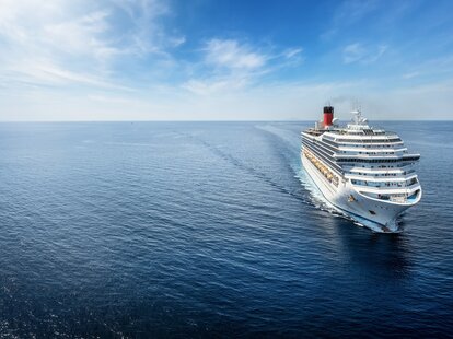 Aerial view of a generic cruise ship traveling with speed over calm ocean