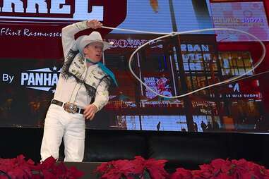 Trick roper Rider Kiesner performs onstage during the "Outside the Barrel" with Flint Rasmussen show during the National Finals Rodeo's Cowboy Christmas at the Las Vegas Convention Center. 