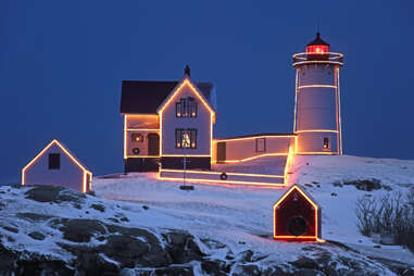 cape neddick lighthouse, frozen, during winter, with lights