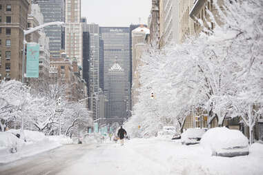 man walking, down frozen street, in manhattan