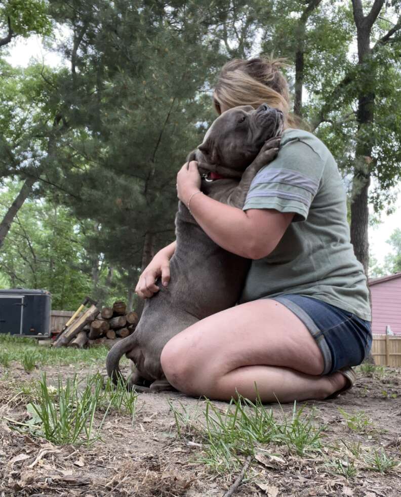 dog hugging woman