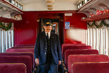 conductor walking through train