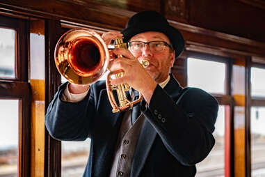 person playing a horn on a train