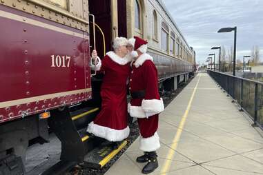 santa and mrs claus kissing on christmas train