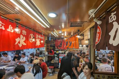 queue of people, lining up for Ron Okonomiyaki, at okonomimura, in hiroshima, japan