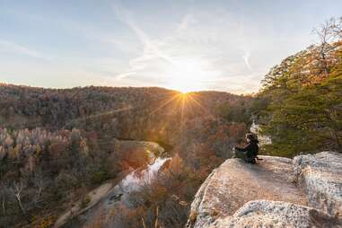 man on a cliff overlooking Eureka Springs arkansas