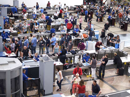 Lines of airplane passengers proceed through the TSA security checkpoint at Denver International Airport in Denver, Colorado.