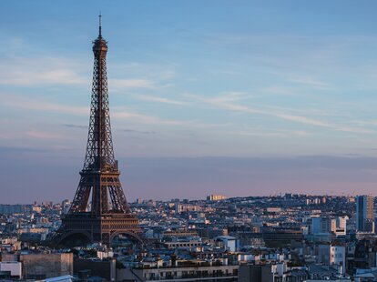 A stunning sunset view of the Eiffel Tower and nearby buildings in Paris, France.