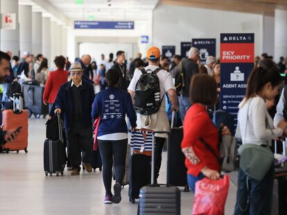 Crowds pass through a terminal at Los Angeles International Airport