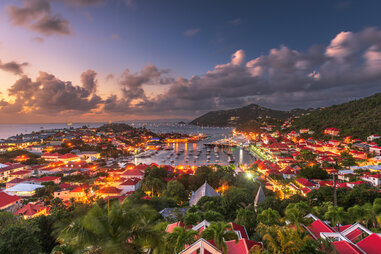 the sun setting over the red-roofed villa of gustavia in st. barts