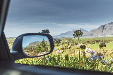 rearview mirror reflecting scenery of stellenbosch wine region