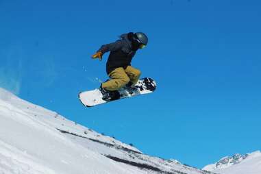snowboarder in mid air at skeetawk ski resort 