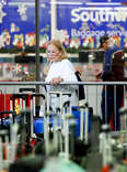 Travelers search for their suitcases in a baggage holding area for Southwest Airlines in December 2022