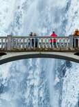 tourists visiting bridge at multnomah falls in winter