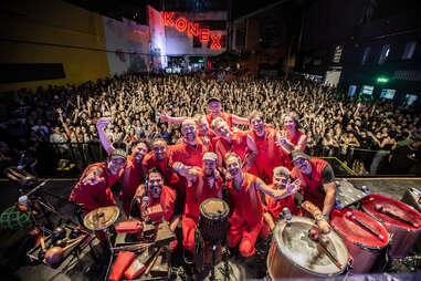 the members of la bombas tel tiempo posing with their audience in the background