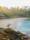 aerial view of surfer at puerto escondido beach at sunset