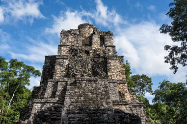 El Castillo or the Castle in the ruins of the Mayan city of Muyil or Chunyaxche in the Sian Ka'an UNESCO World Biosphere Reserve in Quintana Roo, Mexico. 