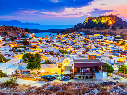 Lindos small whitewashed village and the Acropolis, scenery of Rhodos Island at Aegean Sea.
