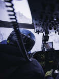 interior shot of a helicopter headed toward a mountain valley in the chugach range in alaska