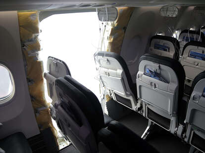 an opening is seen in the fuselage of Alaska Airlines Flight 1282 Boeing 737-9 MAX on January 7, 2024 in Portland, Oregon.
