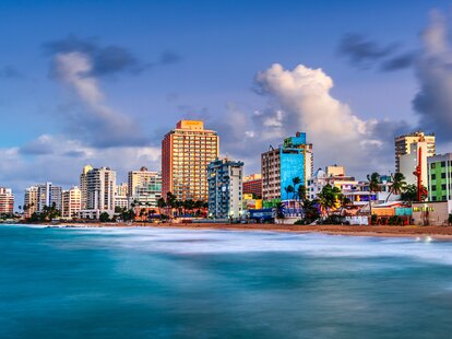 San Juan, Puerto Rico resort skyline on Condado Beach on dusk.