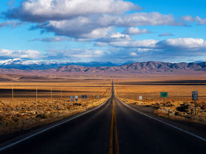 open stretch of us highway 50 in nevada with no cars ahead and blue skies above