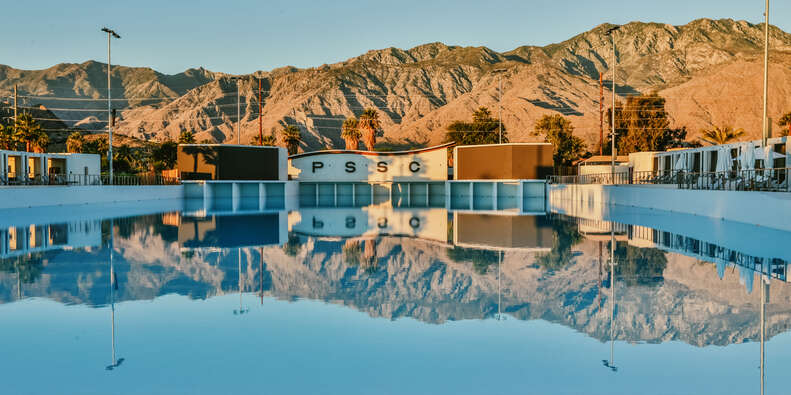 mountains reflecting on a pool at a surf club