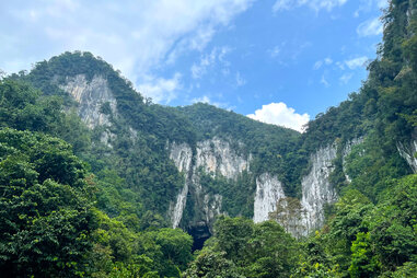 mountain facade at mulu national park surrounded by luscious green forest