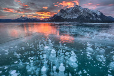 close up of methane bubbles on abraham lake canada