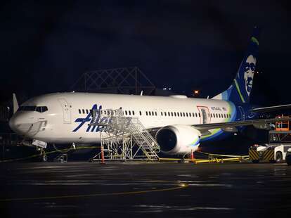 A plastic sheet covers an area of the fuselage of the Alaska Airlines N704AL Boeing 737 MAX 9 aircraft outside a hangar at Portland International Airport on January 8, 2024 in Portland, Oregon.