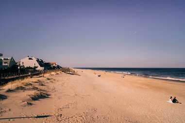 tourists laying on bethany beach, delaware