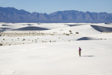 Woman hiker explores White Sands National Monument New Mexico mountains