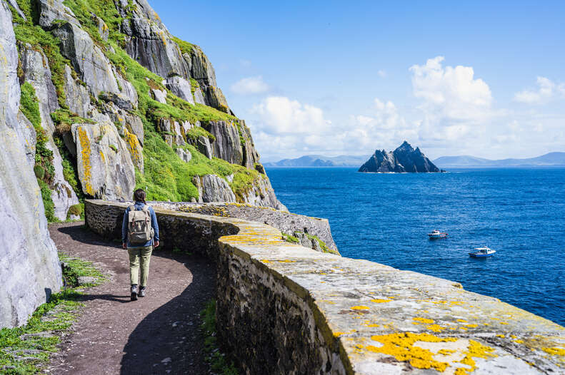 woman exploring skellig michael, county kerry, ireland