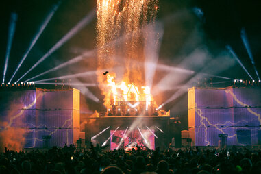 fireworks exploding at an outdooor music festival