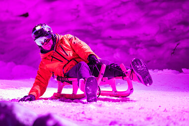 person sliding down mario kart-inspired sled ride in switzerland