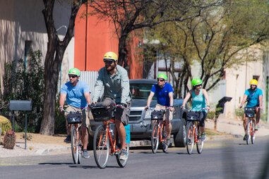 bikers peddling down the street in tucson, arizona