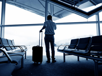 Business class traveler waiting for the flight at the airport