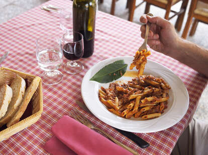 Man eating pasta on vacation in Italy