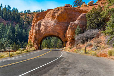 Arch tunnel through rock along scenic highway 12 near Red Canyon. Utah