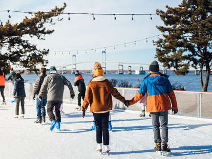 couple holding hands while iceskating in newport, rhode island