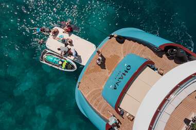 people on Ohana's superyacht deck with a jet ski