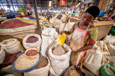 a woman selling dried beans at kimironko market in kigali
