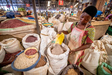 a woman selling dried beans at kimironko market in kigali