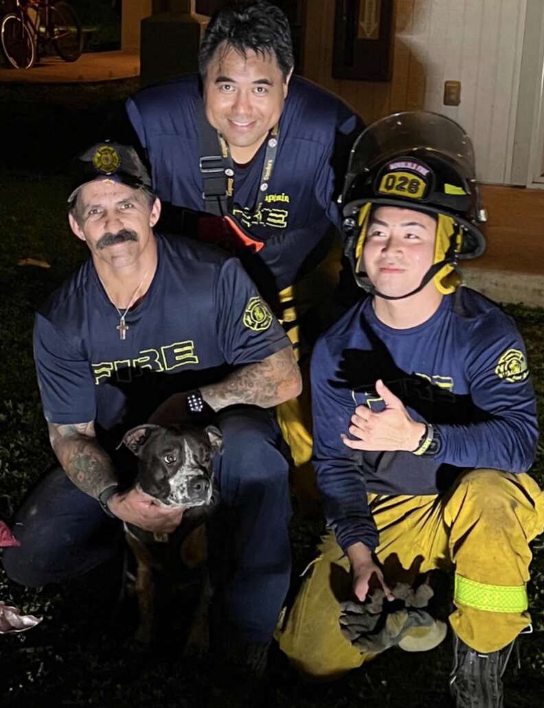 rescuers posing with dog 